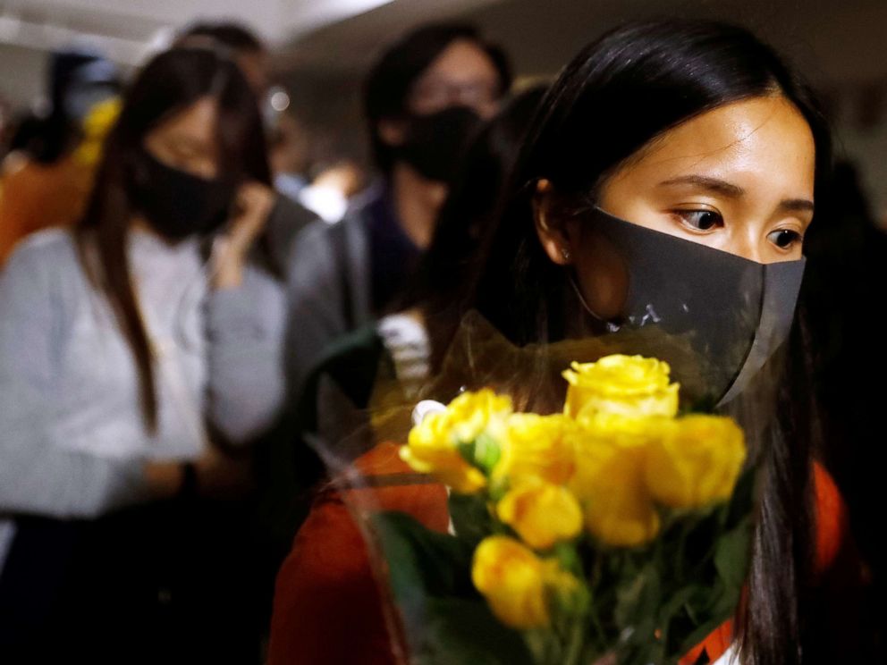 PHOTO:A woman pays tribute with flowers to Chow Tsz-lok in Hong Kong, China, Nov. 8, 2019. 
