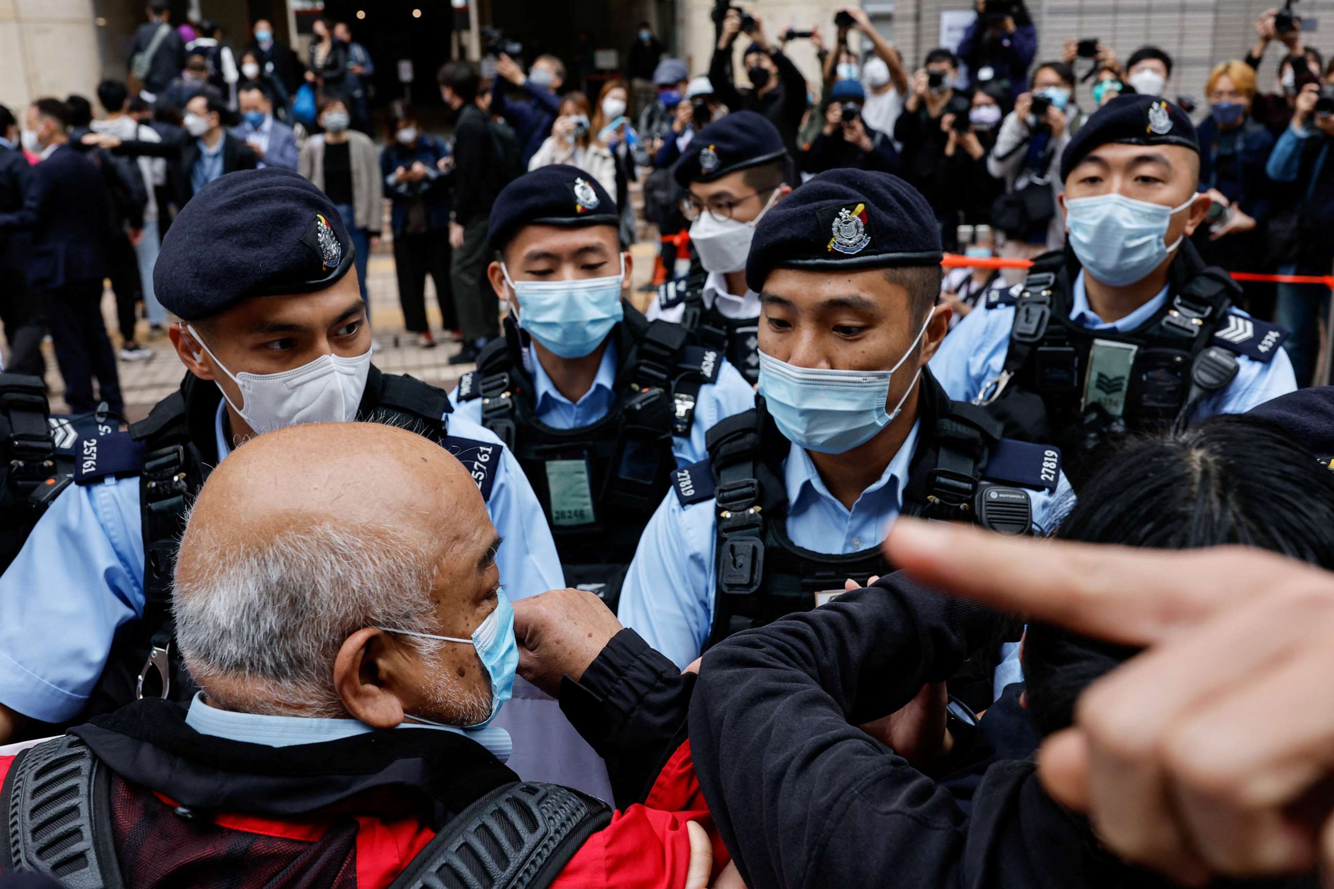 PHOTO: Supporters are surrounded by police outside the West Kowloon Magistrates' Courts building during the hearing of the 47 pro-democracy activists charged with conspiracy to commit subversion under the national security law, in Hong Kong, Feb. 6, 2023.