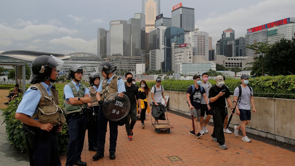 PHOTO: Riot police stand guard as protesters walk outside the Legislative Council in Hong Kong, Thursday, June 13, 2019.