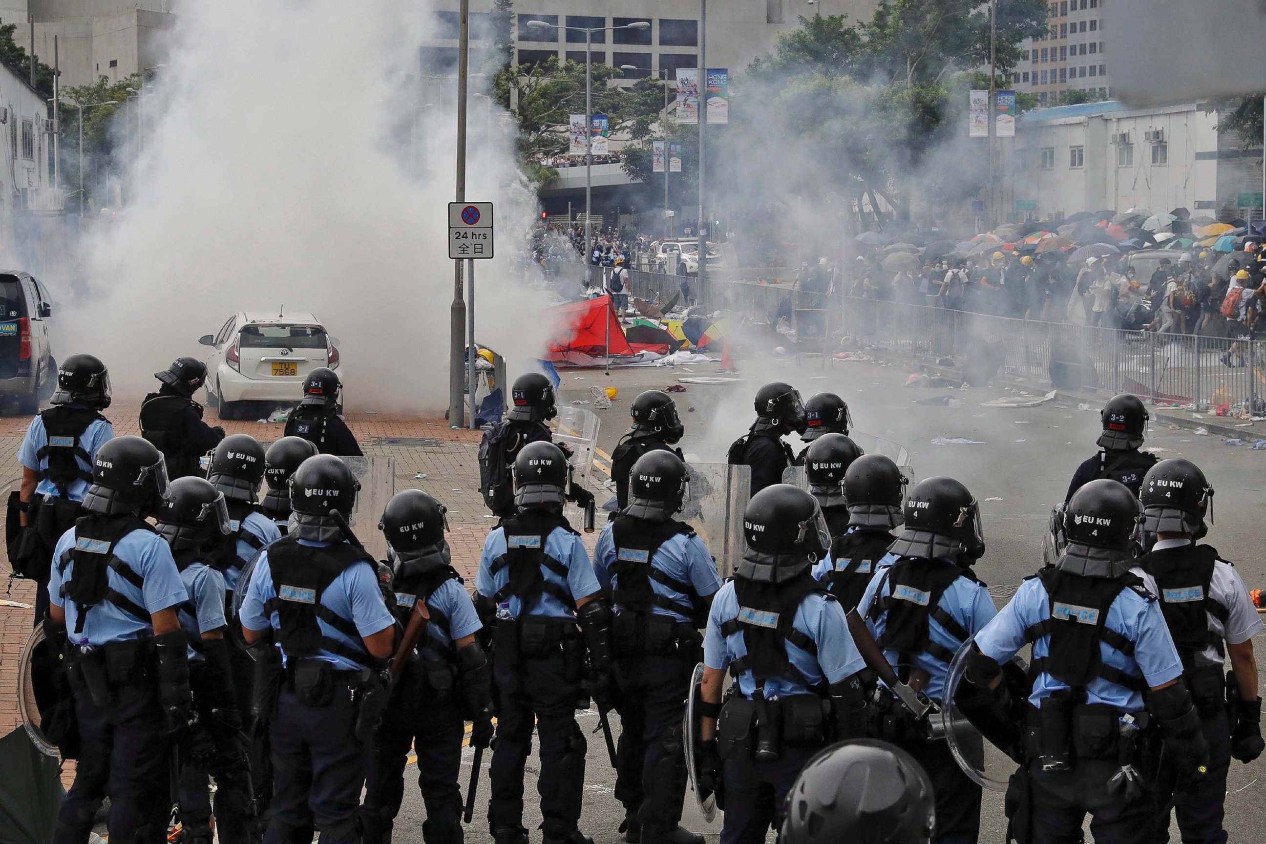 PHOTO: Protesters run away from riot police firing tear gas outside the Legislative Council during a massive demonstration in Hong Kong, Wednesday, June 12, 2019.