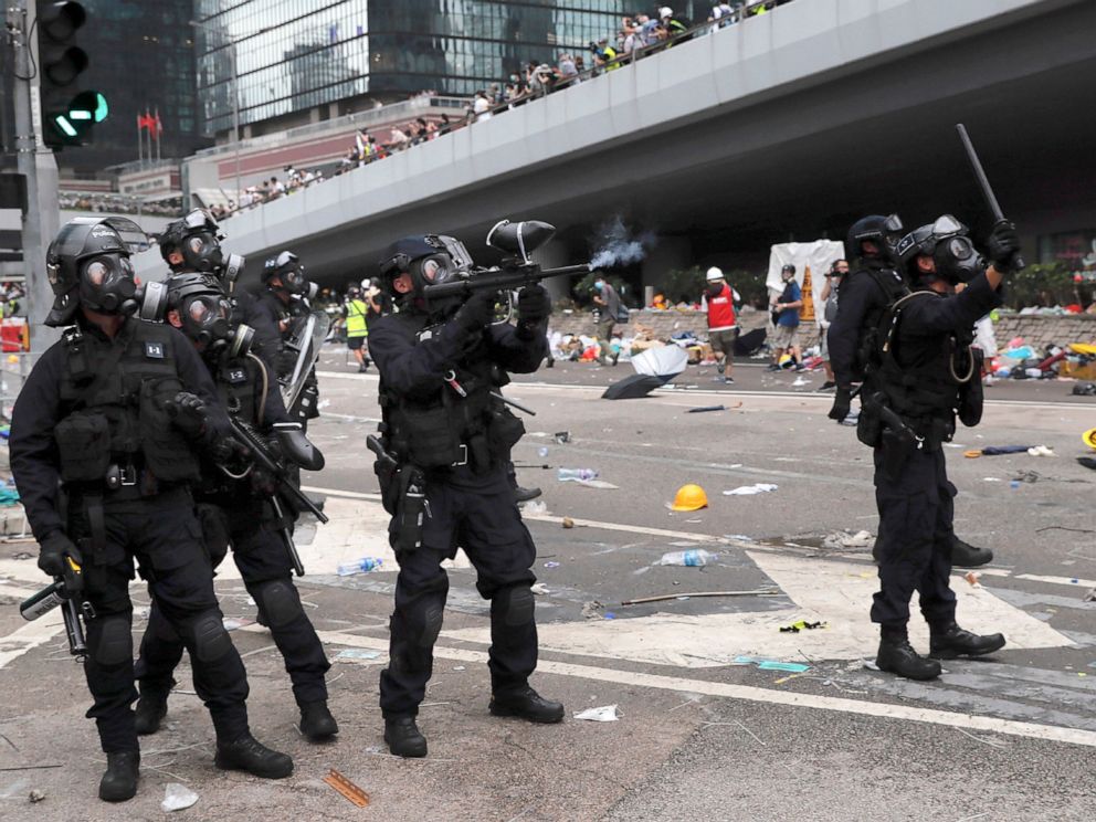 driving street PHOTO: A policeman fires what a crowd control weapon towards protesters near the Legislative Council in Hong Kong, Wednesday, June 12, 2019.