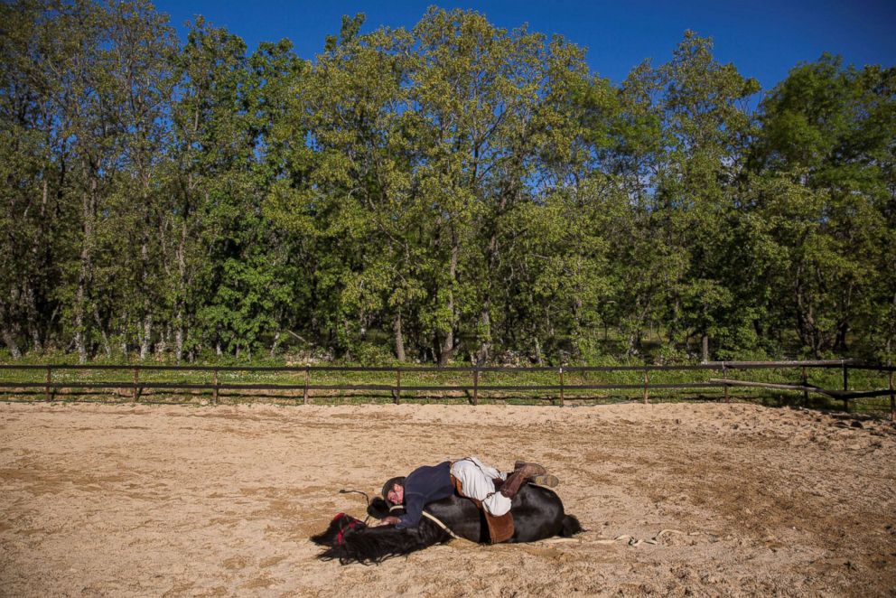 PHOTO: Fernando Noailles, emotional therapist, lays on top of his horse named Madrid in Guadalix de la Sierra, Spain, May 31, 2016.