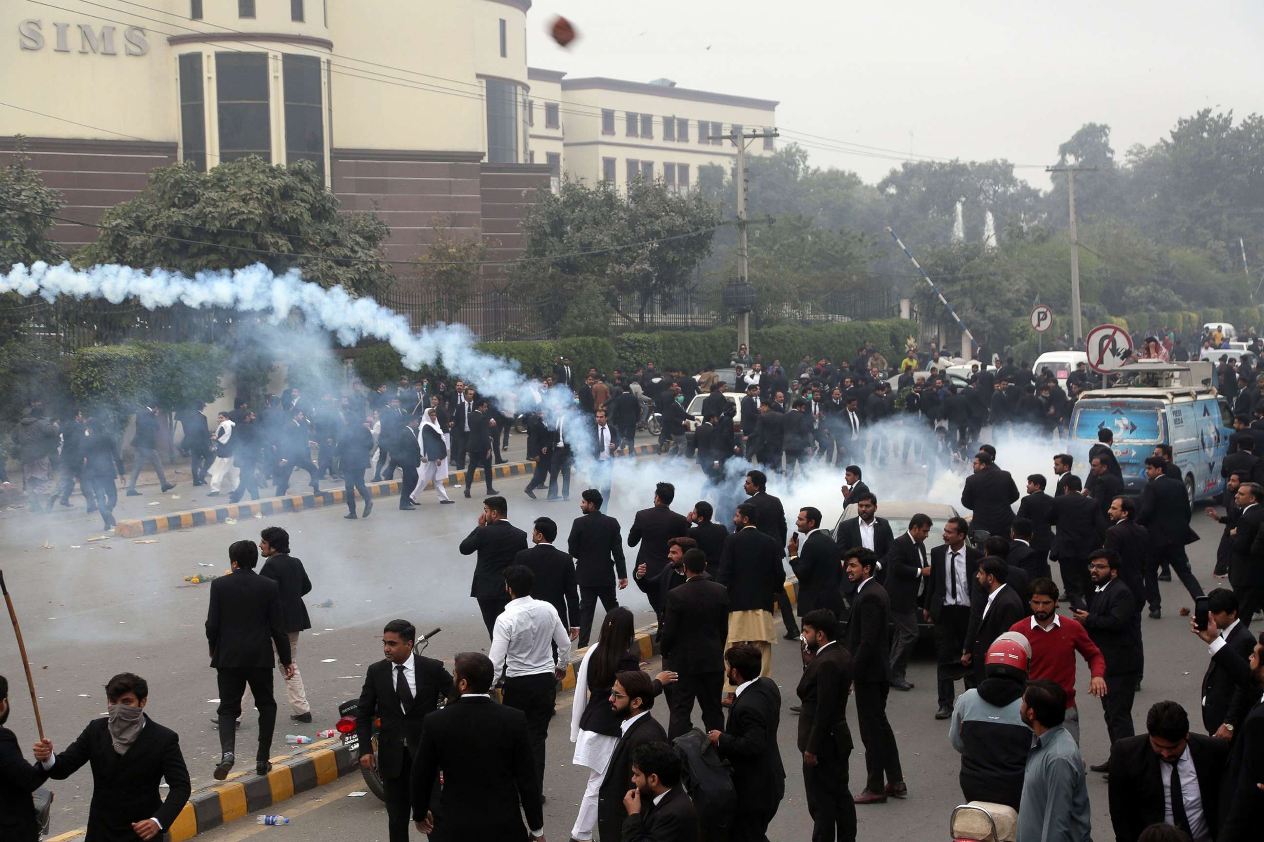 PHOTO: Policemen fire tear gas shells during clashes between lawyers and doctors outside the Punjab Institute of Cardiology, in Lahore, Pakistan, Dec. 11, 2019.
