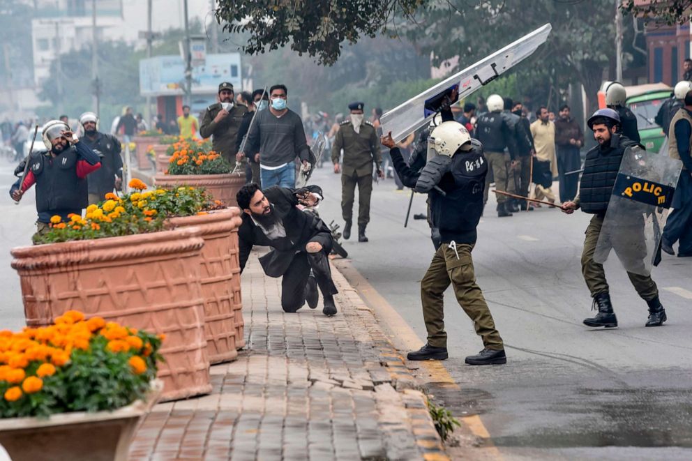 PHOTO: A policeman confronts a lawyer during a clash between lawyers and doctors in Lahore on Dec. 11, 2019. A group of lawyers attacked doctors at a cardiac hospital in Pakistan's eastern city of Lahore, officials and ministers said.
