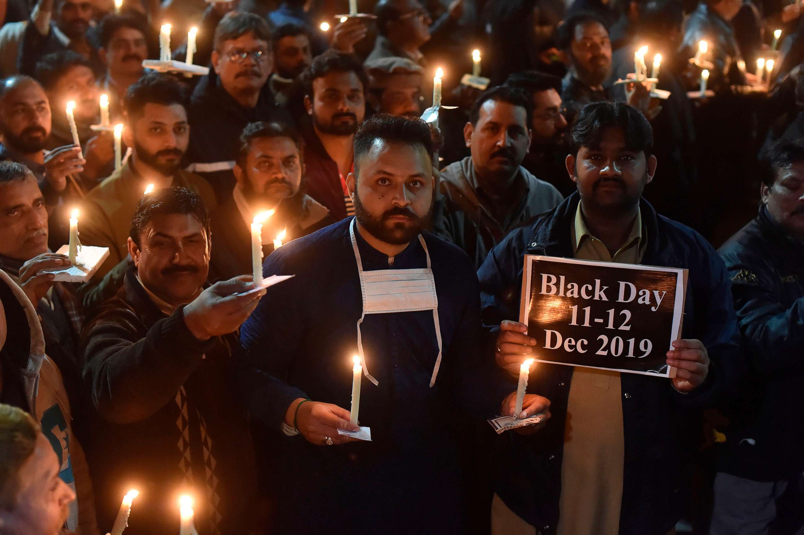PHOTO: Paramedic staff members participate in a candlelight vigil for the victims who lost their lives during an attack on Dec. 11 by a group of lawyers on Punjab Institute of Cardiology  in Lahore, Dec. 13, 2019.