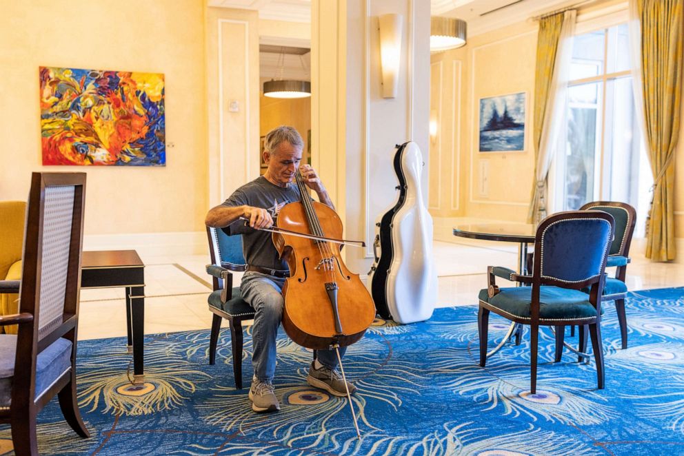 PHOTO: Jim Connors, a resident of Tampa and member of the Florida Orchestra, practices his cello in the cafe of the Waldorf Astoria hotel at Walt Disney World Resort in Orlando, Fla., Sept. 28, 2022.