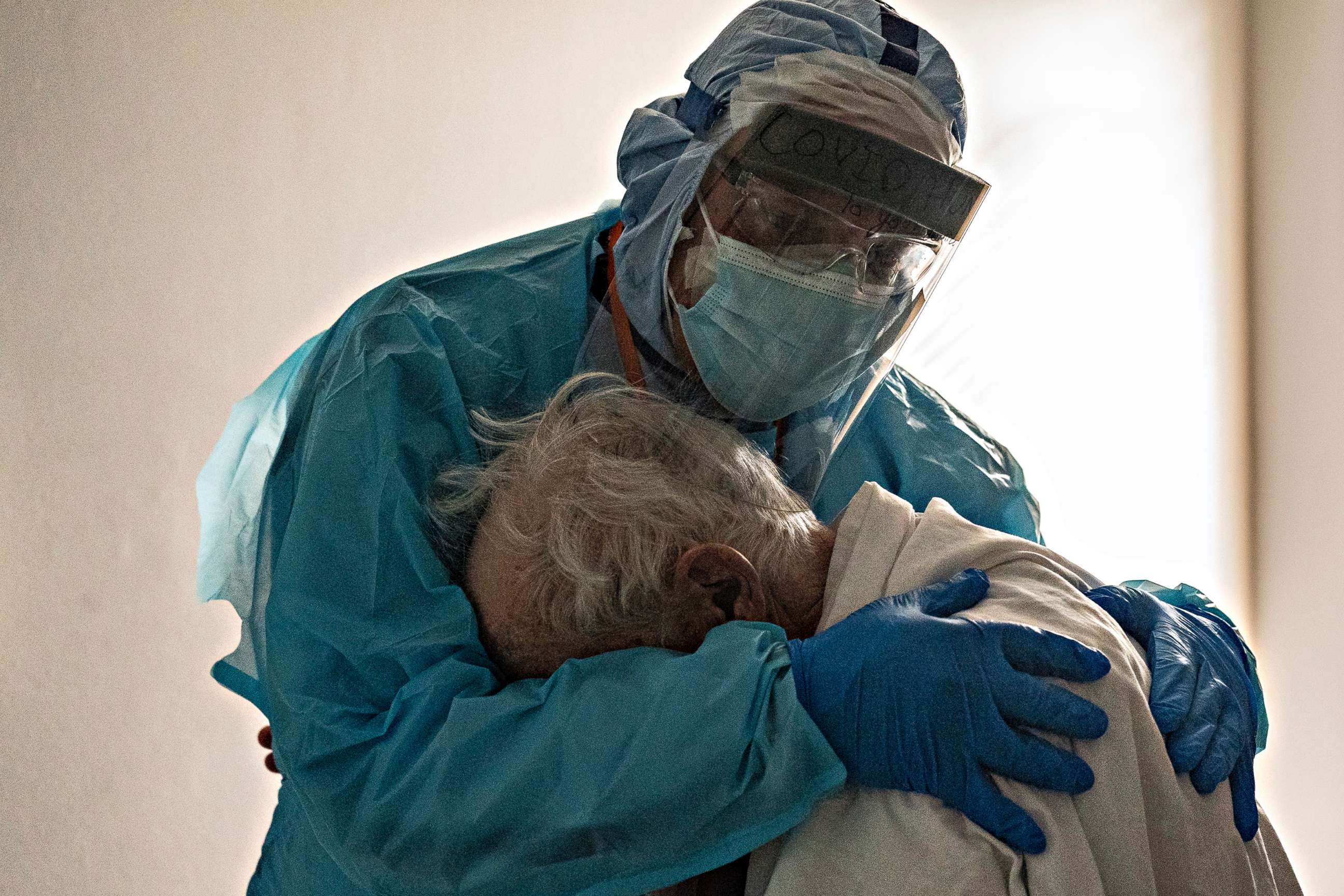 PHOTO: Dr. Joseph Varon hugs and comforts a patient in the COVID-19 ICU Thanksgiving Day at the United Memorial Medical Center on Nov. 26, 2020, in Houston.