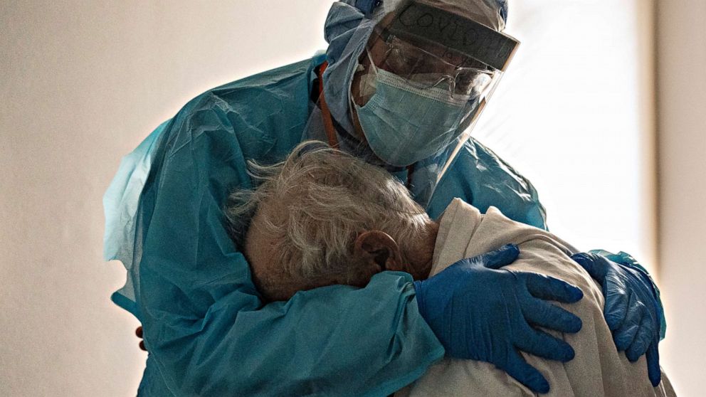 PHOTO: Dr. Joseph Varon hugs and comforts a patient in the COVID-19 ICU Thanksgiving Day at the United Memorial Medical Center on Nov. 26, 2020, in Houston.