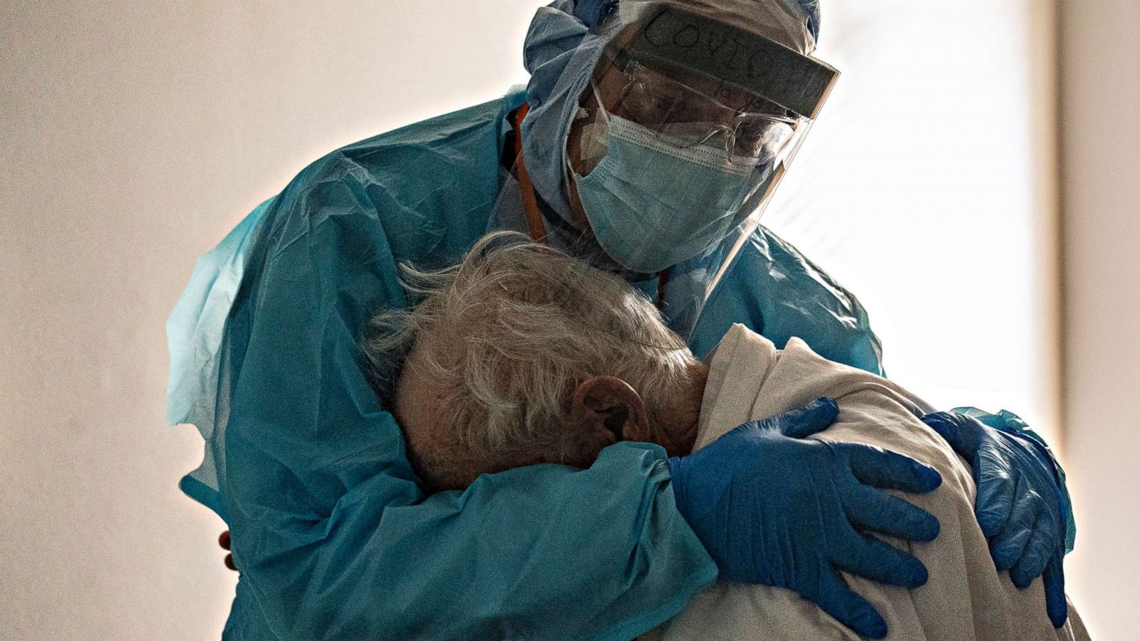 PHOTO: Dr. Joseph Varon hugs and comforts a patient in the COVID-19 ICU Thanksgiving Day at the United Memorial Medical Center on Nov. 26, 2020, in Houston.