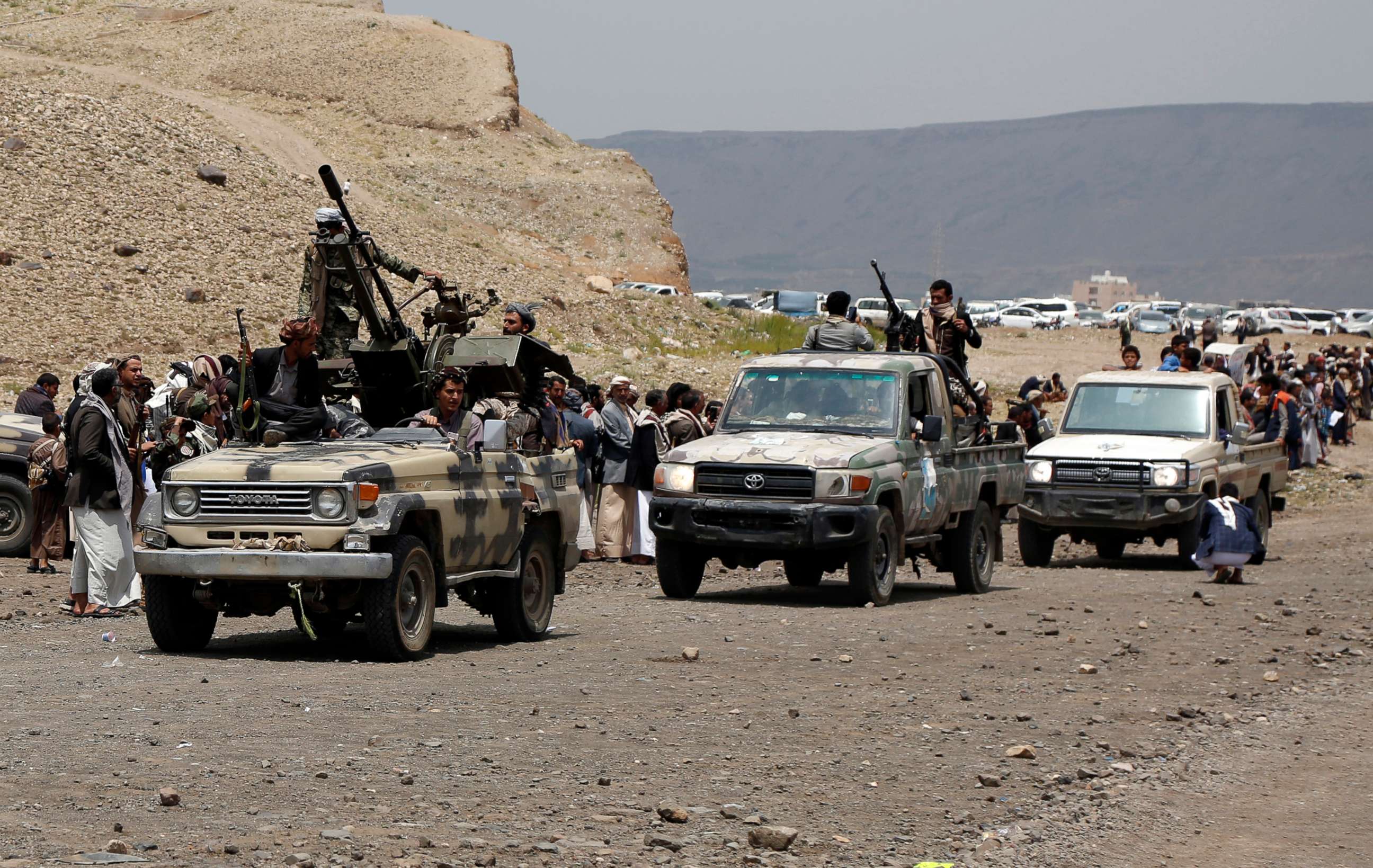 PHOTO: In this July 8, 2020, file photo, tribesmen loyal to the Houthi group ride trucks mounted with machine guns during an armed tribal gathering on the outskirts of Sana'a, Yemen.