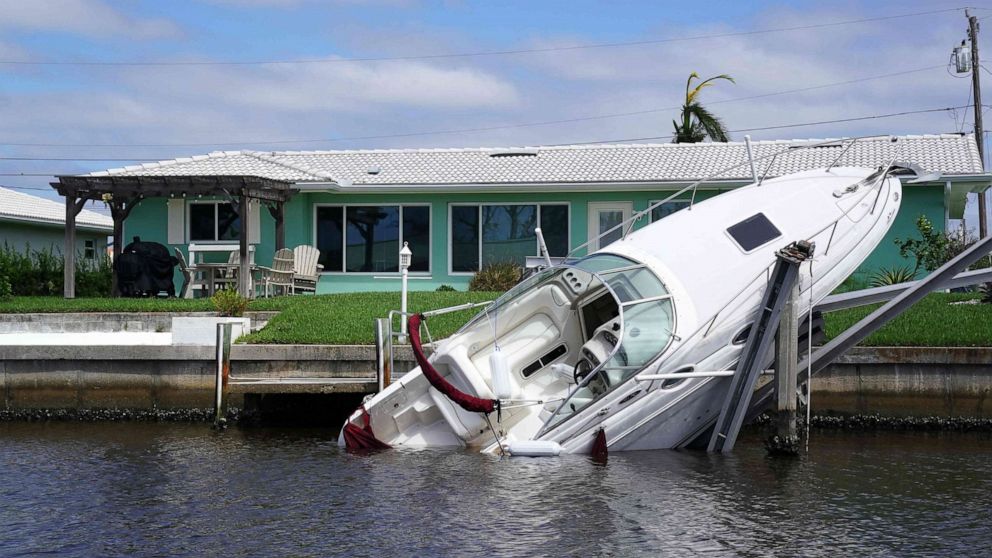 PHOTO: A boat lays sideways in the canal in the aftermath of Hurricane Ian in Punta Gorda, Fla., Sept. 29, 2022. 