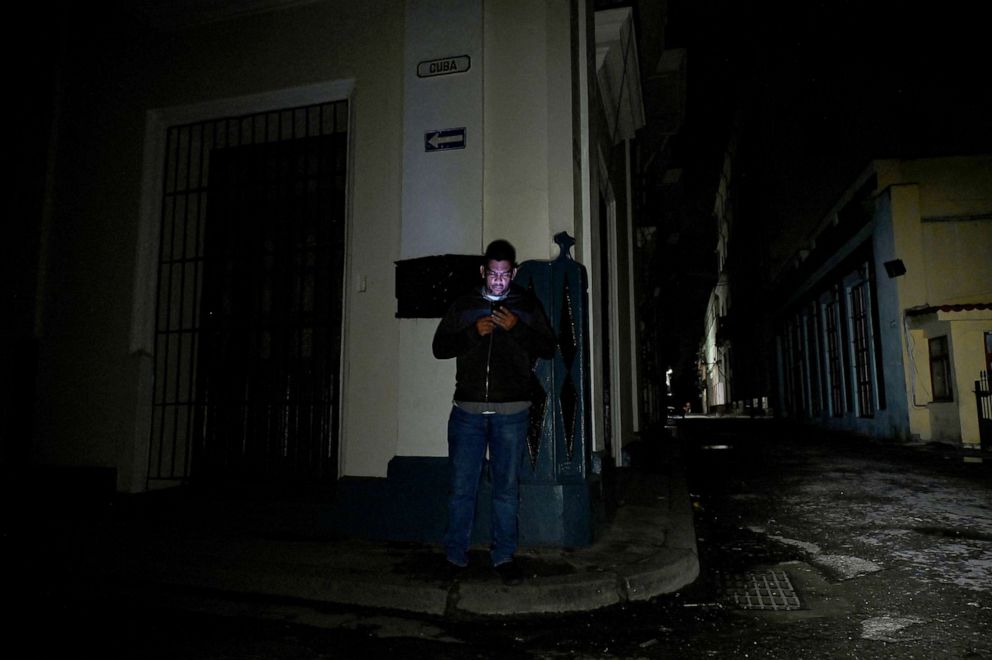 PHOTO: A man uses his cell phone on a street during a blackout in Havana, on Sept. 27, 2022.