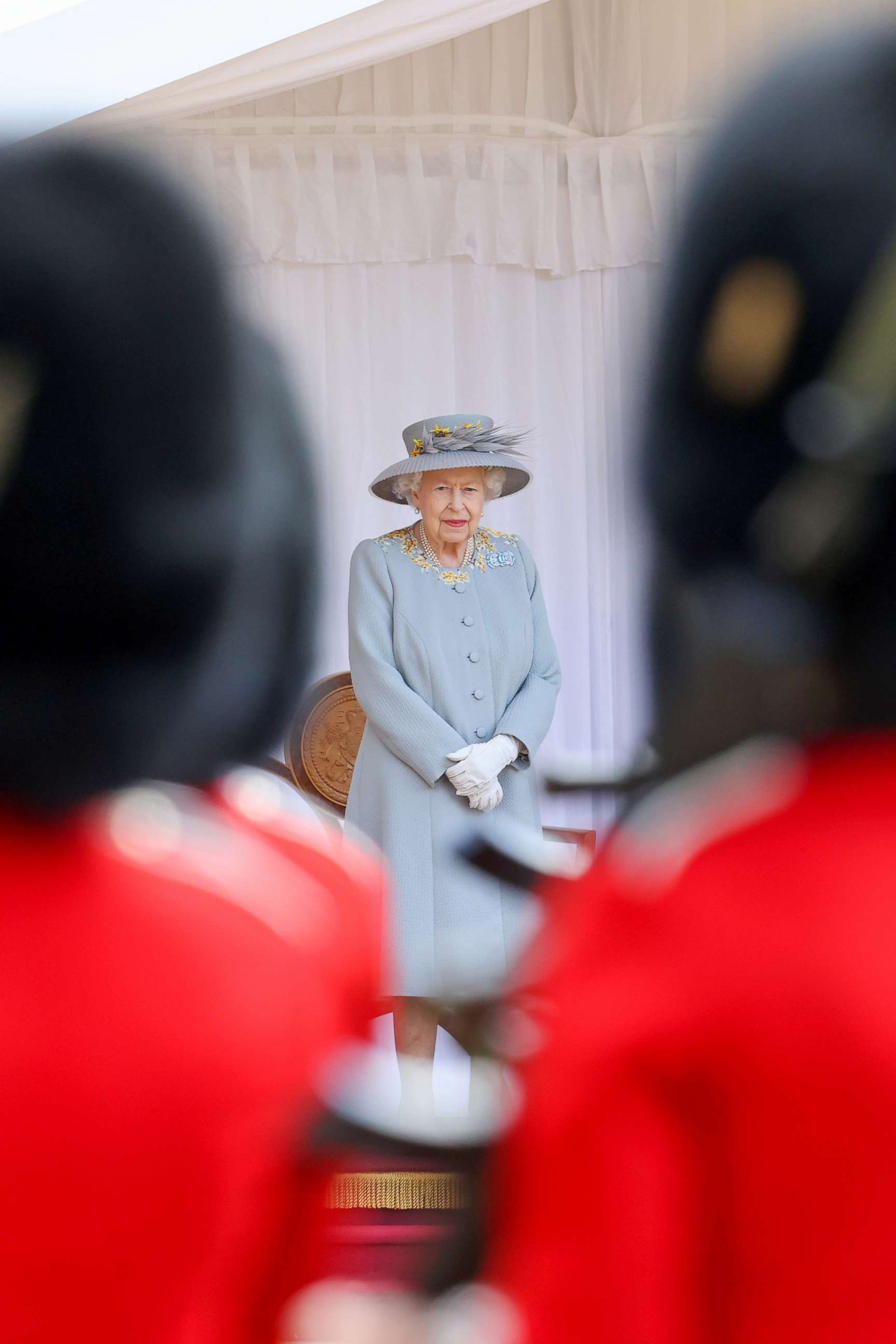 PHOTO: Queen Elizabeth II watches the Royal Air Force "Red Arrows" fly over Windsor Castle during a military ceremony to mark her Official Birthday  in Windsor, England, June 12, 2021.