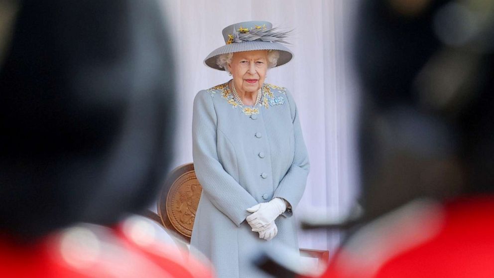 PHOTO: Queen Elizabeth II watches the Royal Air Force "Red Arrows" fly over Windsor Castle during a military ceremony to mark her Official Birthday  in Windsor, England, June 12, 2021.
