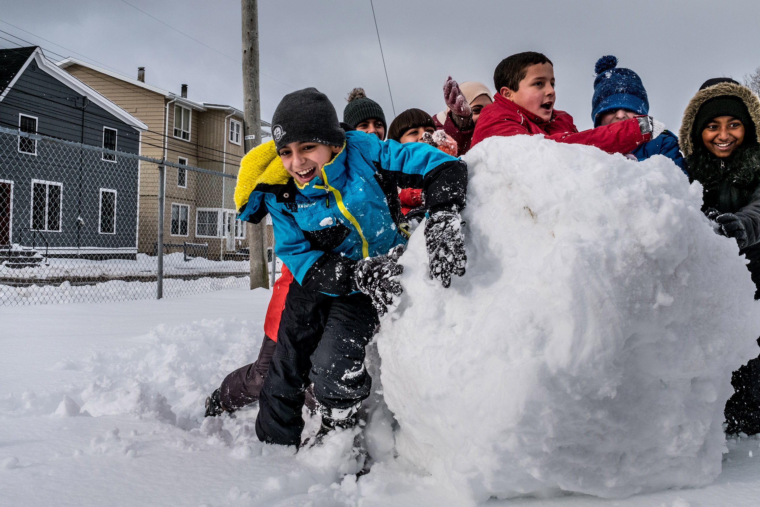 PHOTO: Basel Alrashdan, 11, plays with other sixth graders in the snow at St. Jean Elementary School in Charlottetown on Prince Edward Island, Canada, on Dec. 13, 2016.