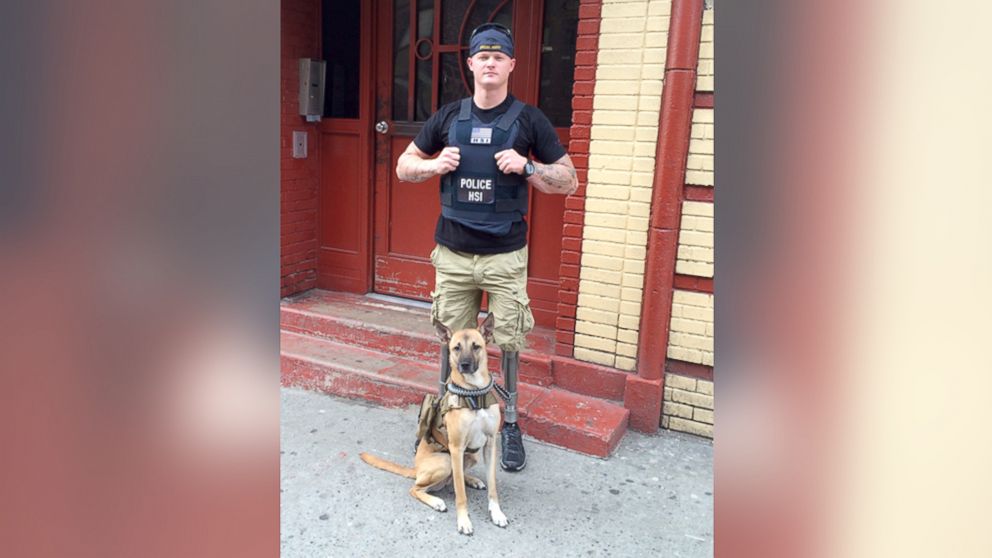 Sgt. Justin Gaertner, who lost both legs in Afghanistan, stands with his service dog Gunner.