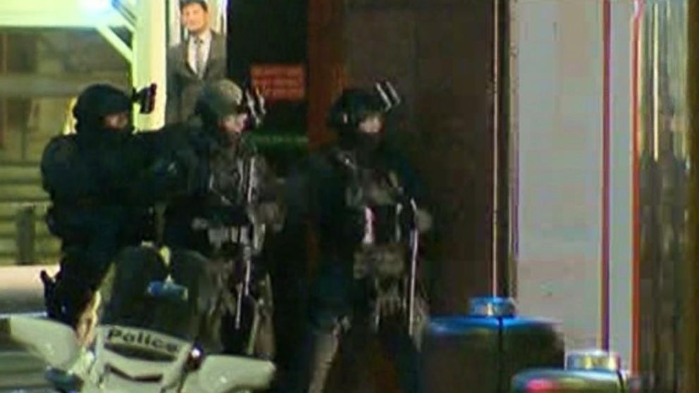 PHOTO: Armed police enter a cafe where hostages are being held at Martin Place in the central business district of Sydney, Australia, Dec. 15, 2014.