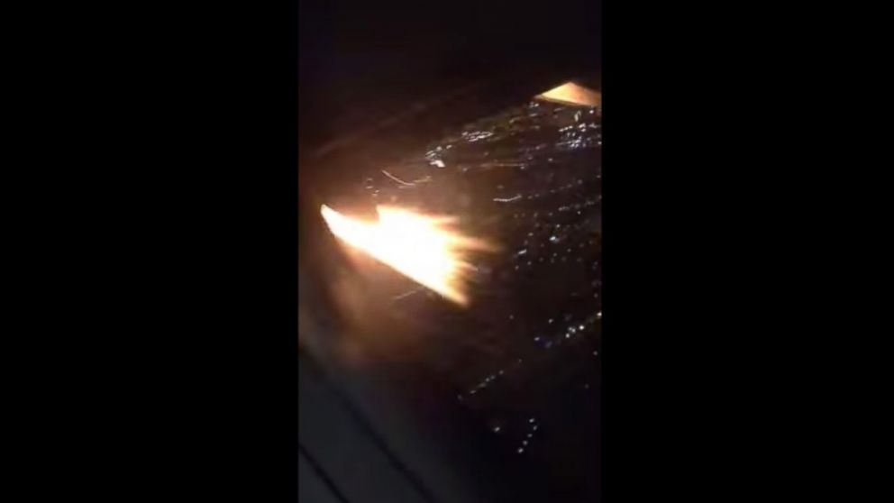 Flames are seen from a plane window in this video posted to YouTube on Feb. 4, 2015. 