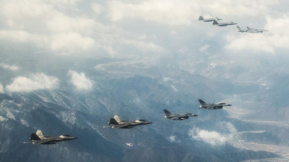 PHOTO: Four U.S. Air Force F-22 "Raptor" fighter aircraft from Kadena Air Base, Japan, fly over the skies of South Korea. The Raptors were joined by four F-15 Slam Eagles and U.S. Air Force F-16 Fighting Falcons.