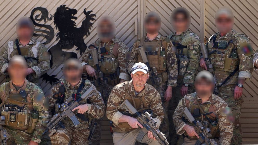 PHOTO: Brett Jones, right of center, poses with CIA GRS troops on a recent deployment.