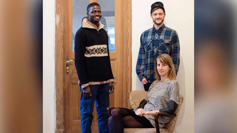 PHOTO: "Refugees Welcome" founders Mareike Geiling and Jonas Kakoschke pose with Bakary, a refugee from Mali that they hosted, in an undated handout photo.