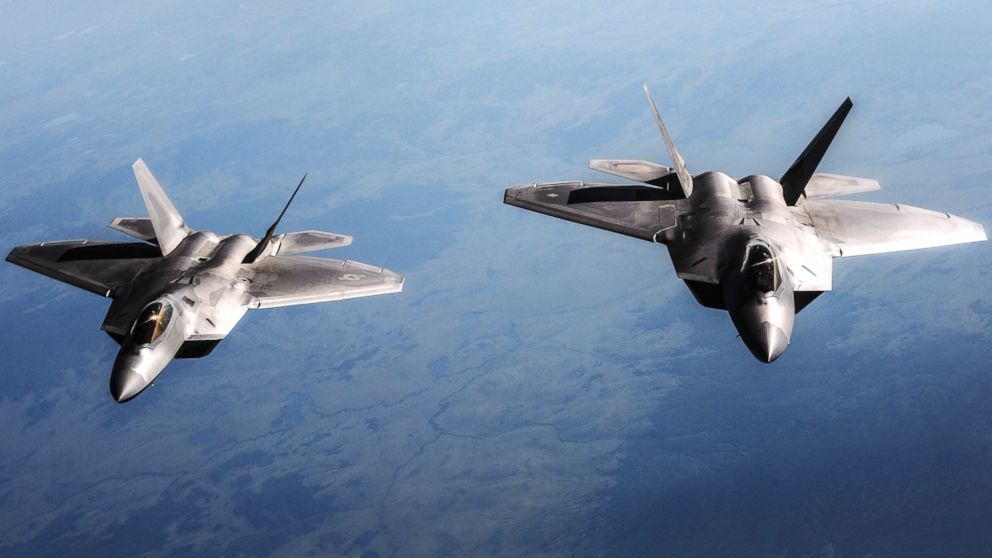 PHOTO: Two U.S. Air Force F-22 Raptor aircraft fly behind a KC-135 Stratotanker aircraft, not shown, during Red Flag-Alaska 13-3 over the Joint Pacific Alaska Range Complex Aug. 14, 2013.
