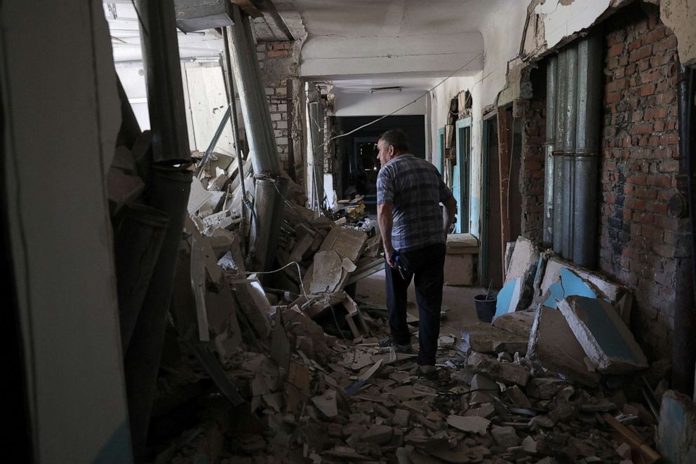 PHOTO: A resident looks out from inside the destroyed city hospital of Hulyaypole, Zaporizhzhia Region, Ukraine, July 6, 2023.