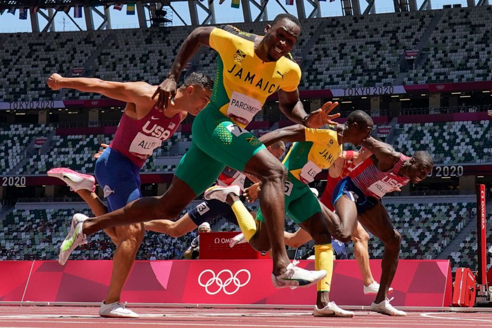 PHOTO: Hansle Parchment, of Jamaica, wins the men's 110-meter hurdles final past Grant Holloway, of the United States, at the 2020 Summer Olympics, Thursday, Aug. 5, 2021, in Tokyo, Japan.
