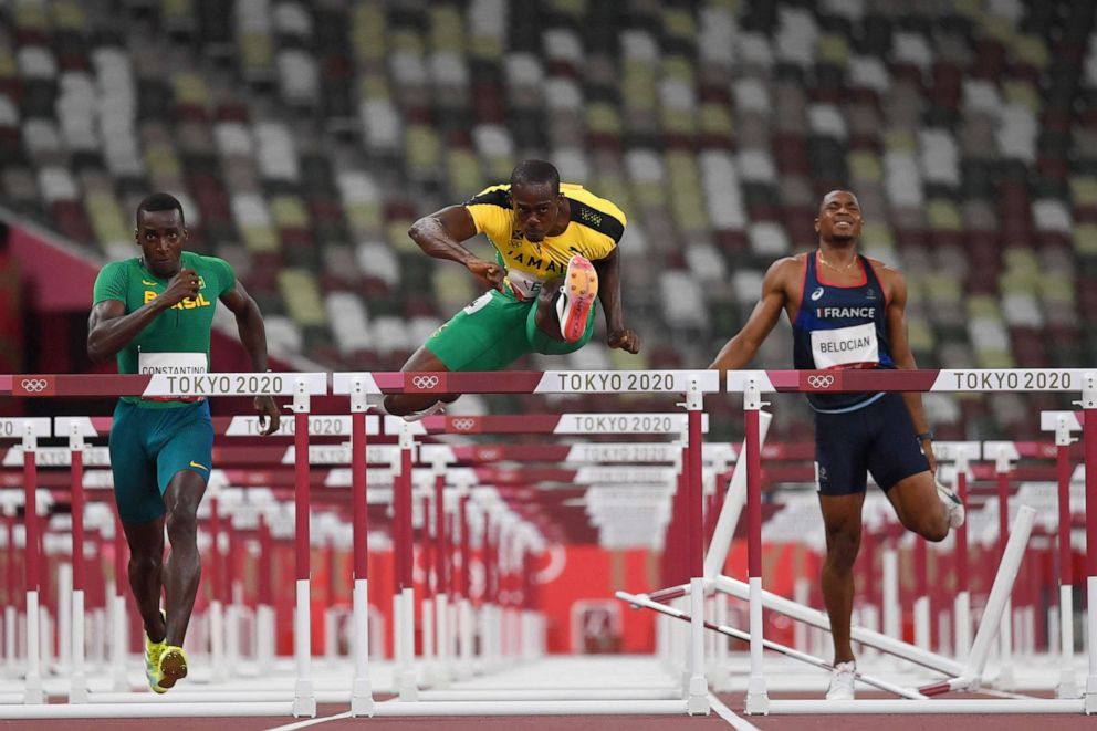 PHOTO: From left, Brazil's Gabriel Constantino, Jamaica's Ronald Levy and France's Wilhem Belocian compete in the men's 110m hurdles heats during the Tokyo 2020 Olympic Games at the Olympic Stadium in Tokyo on Aug. 3, 2021.