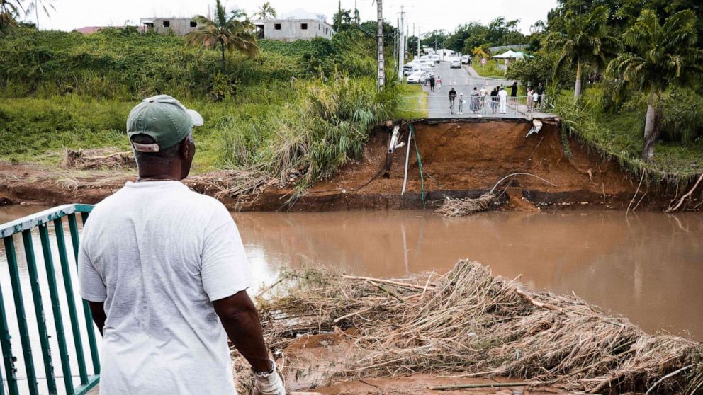 PHOTO: A pedestrian looks at a destroyed bridge after the passage of Fiona storm at the Pont de Goyave, on the French island of Guadeloupe, on Sept. 18, 2022.