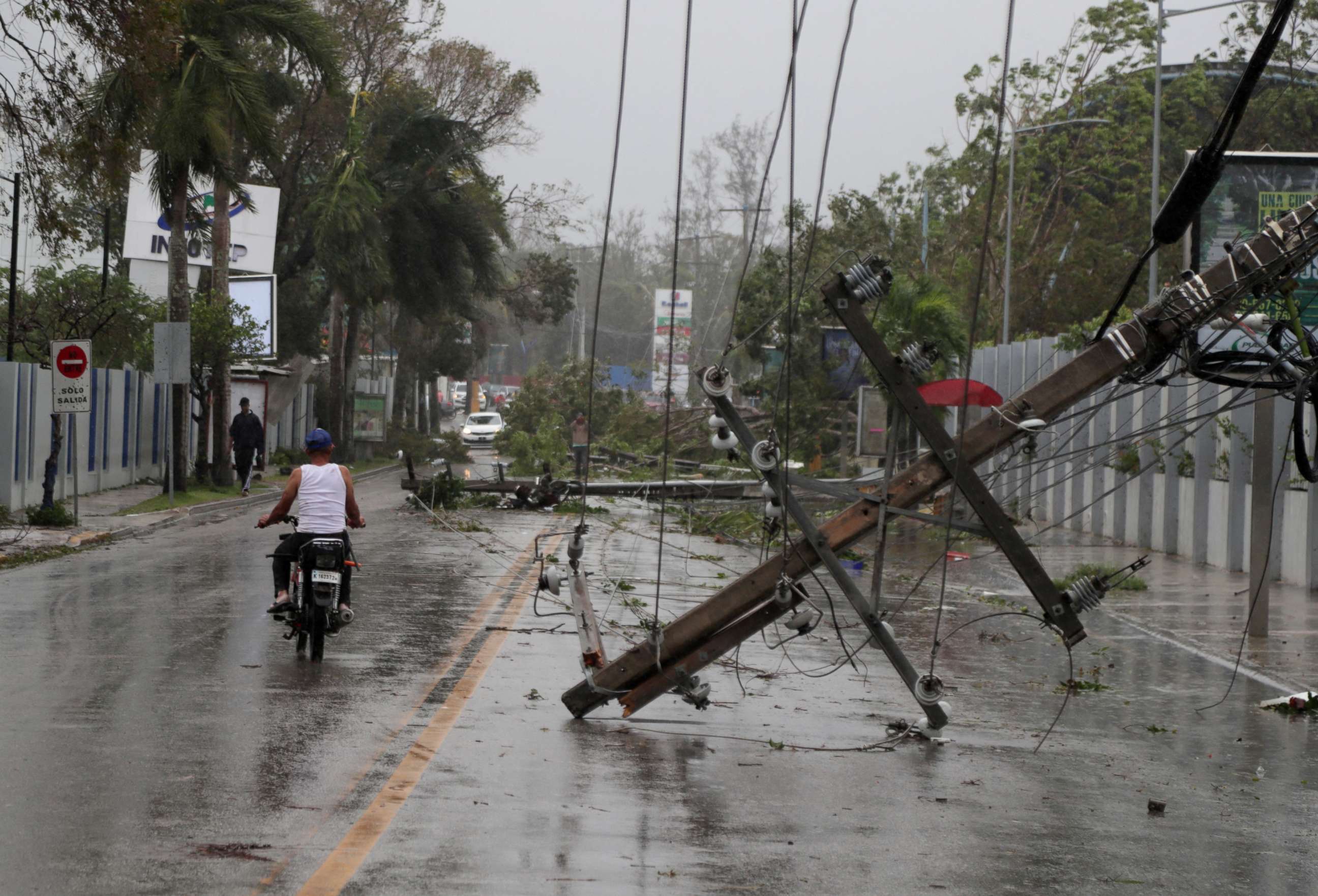 PHOTO: A man on a motorcycle rides past fallen power lines in the aftermath of Hurricane Fiona in Higuey, Dominican Republic, Sept. 19, 2022.