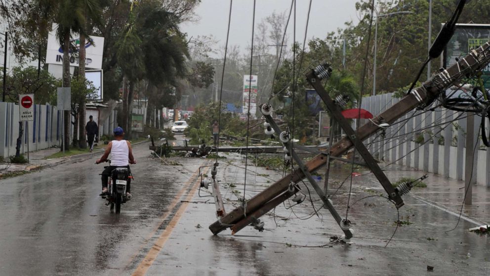 PHOTO: A man on a motorcycle rides past fallen power lines in the aftermath of Hurricane Fiona in Higuey, Dominican Republic, Sept. 19, 2022.