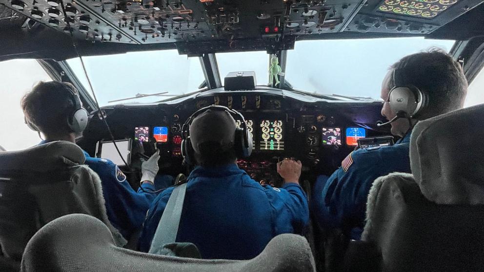 PHOTO: Two NOAA Corps pilots and a flight engineer at the controls of NOAA Lockheed WP-3D Orion N42RF during a flight into Hurricane Ian on September 27, 2022.