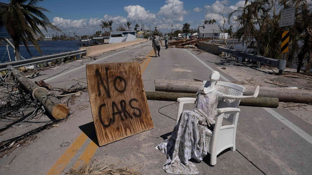 PHOTO: A man walks on a street in the aftermath of Hurricane Ian in Matlacha, Fla., Oct. 1, 2022.