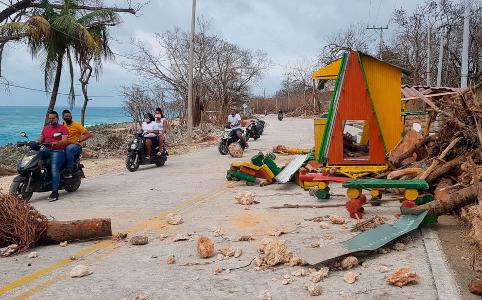 PHOTO: Motorcyclists pass debris on the road after the passing of Hurricane Iota on San Andres Island, Colombia, Nov. 17, 2020.
