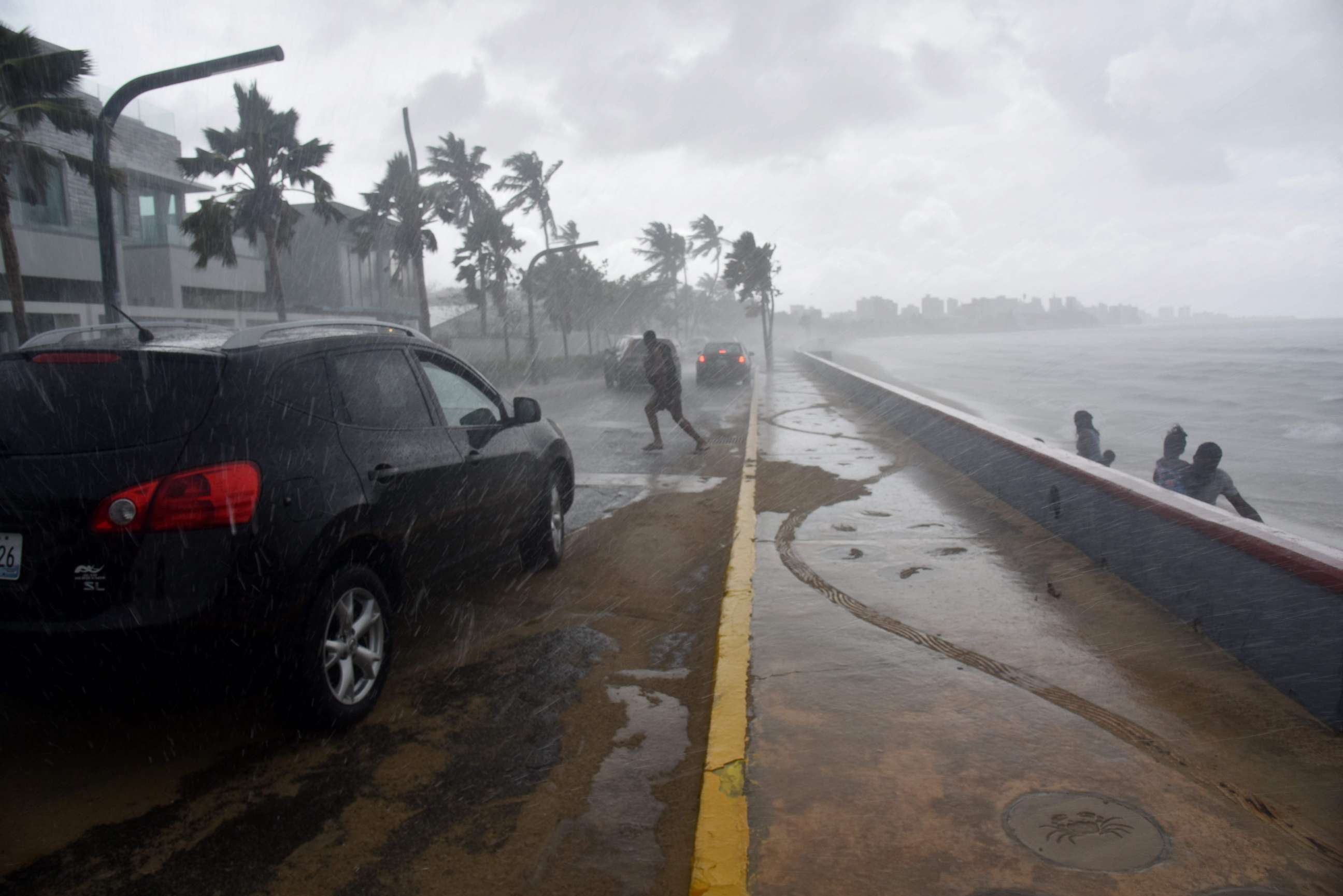 PHOTO: Tourists flee from the rain on a beach in San Juan, Puerto Rico, Sept. 19, 2017, prior to the arrival of Hurricane Maria.