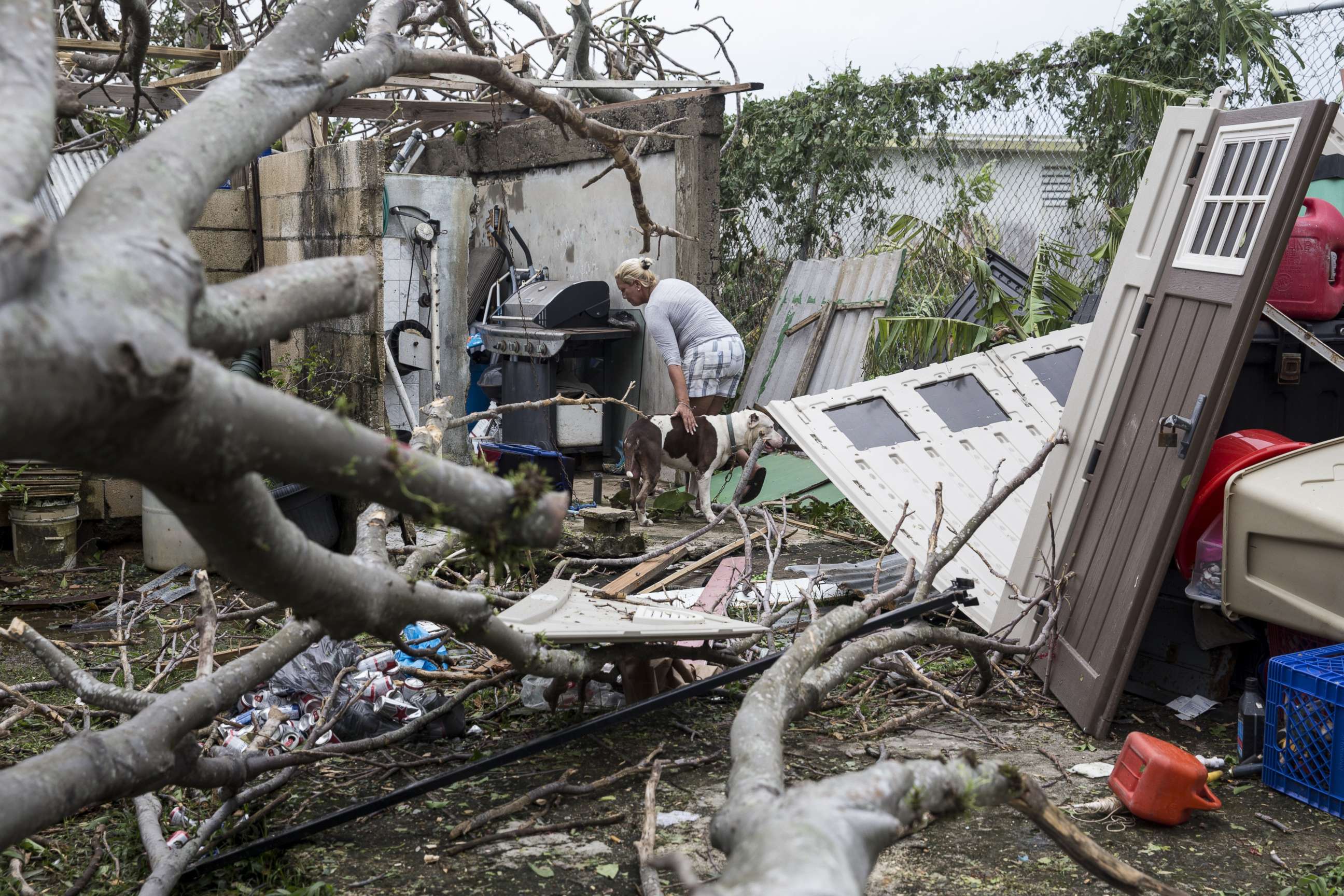 PHOTO: A resident surveys the damage to her property after Hurricane Maria made landfall, Sept. 21, 2017, in the Guaynabo suburb of San Juan, Puerto Rico.