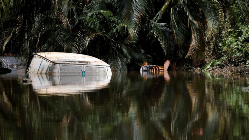 PHOTO: A car submerged in flood waters is seen close to the dam of the Guajataca lake after the area was hit by Hurricane Maria in Guajataca, Puerto Rico, Sept. 23, 2017.