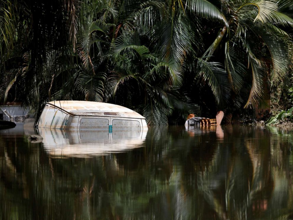 PHOTO: A car submerged in flood waters is seen close to the dam of the Guajataca lake after the area was hit by Hurricane Maria in Guajataca, Puerto Rico, Sept. 23, 2017.
