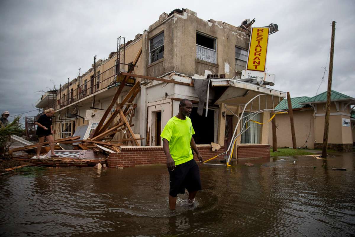 PHOTO: A man walks near a damaged apartment building following Hurricane Michael in Panama City, Fla., Oct. 10, 2018. Hurricane Michael charged through Florida and into Georgia on Wednesday, lashing the Panhandle with rains and heavy winds. 