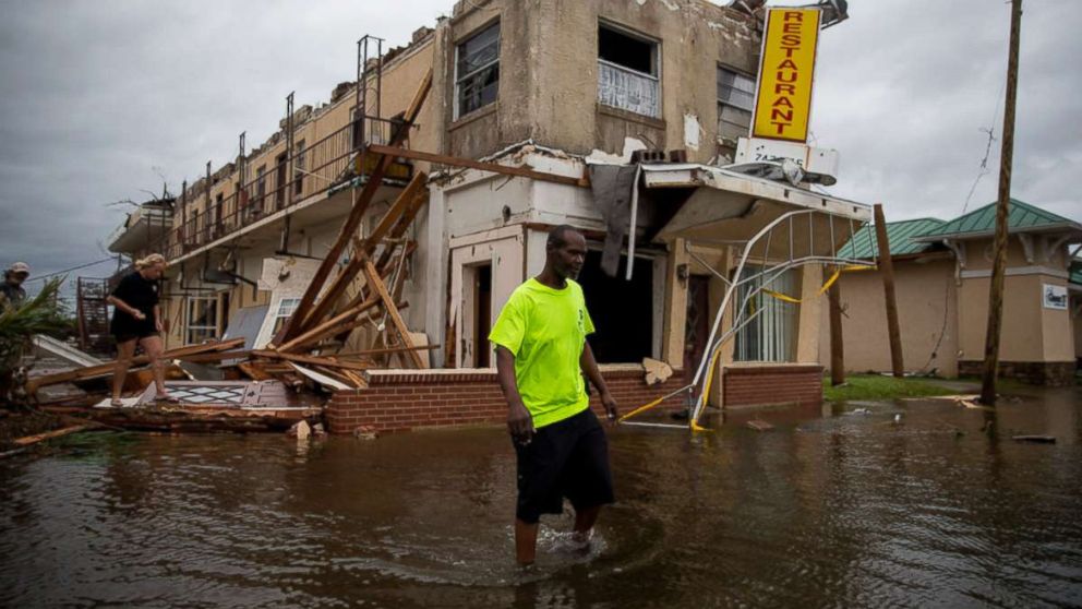 PHOTO: A man walks near a damaged apartment building following Hurricane Michael in Panama City, Fla., Oct. 10, 2018. Hurricane Michael charged through Florida and into Georgia on Wednesday, lashing the Panhandle with rains and heavy winds. 