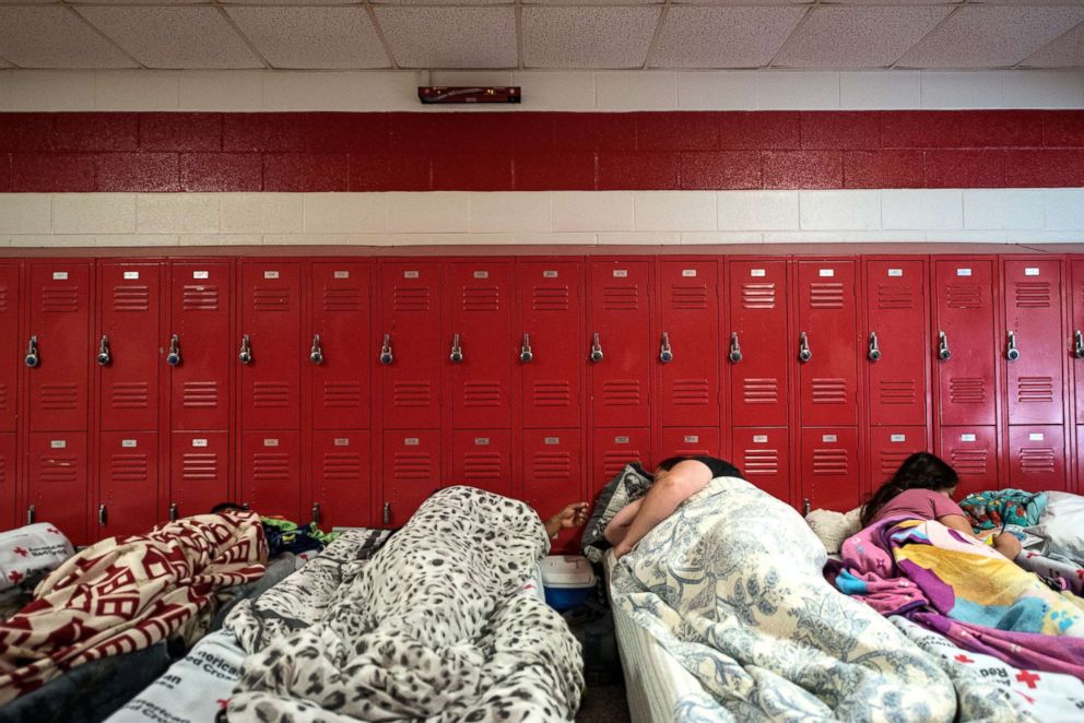 PHOTO: People and pets evacuate ahead of the forecasted landfall of Hurricane Florence and seek shelter at Burgaw Middle School in Burgaw, N.C., on Sept. 2018. 