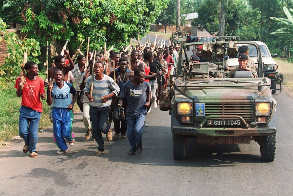 PHOTO: French soldiers on patrol pass ethnic Hutu troops from the Rwandan government forces near Gisenyie, southern Rwanda, on June 27, 1994.