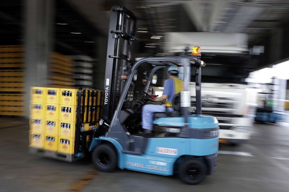 PHOTO: A worker transports crates of beer at a Kirin Brewery Co. plant with a hydrogen powered fuel cell forklift during a demonstration of a hydrogen supply chain system in Yokohama, Japan, July 12, 2017.