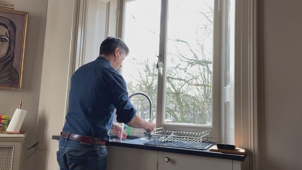 PHOTO: Ian Pannell, senior foreign correspondent for ABC News, washes his hands while looking out of the window of his apartment in the U.K. during a 14-day self-quarantine after reporting in Daegu, South Korea, during the COVID-19 outbreak.