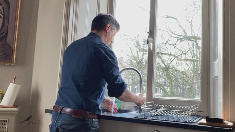 PHOTO: Ian Pannell, senior foreign correspondent for ABC News, washes his hands while looking out of the window of his apartment in the U.K. during a 14-day self-quarantine after reporting in Daegu, South Korea, during the COVID-19 outbreak.