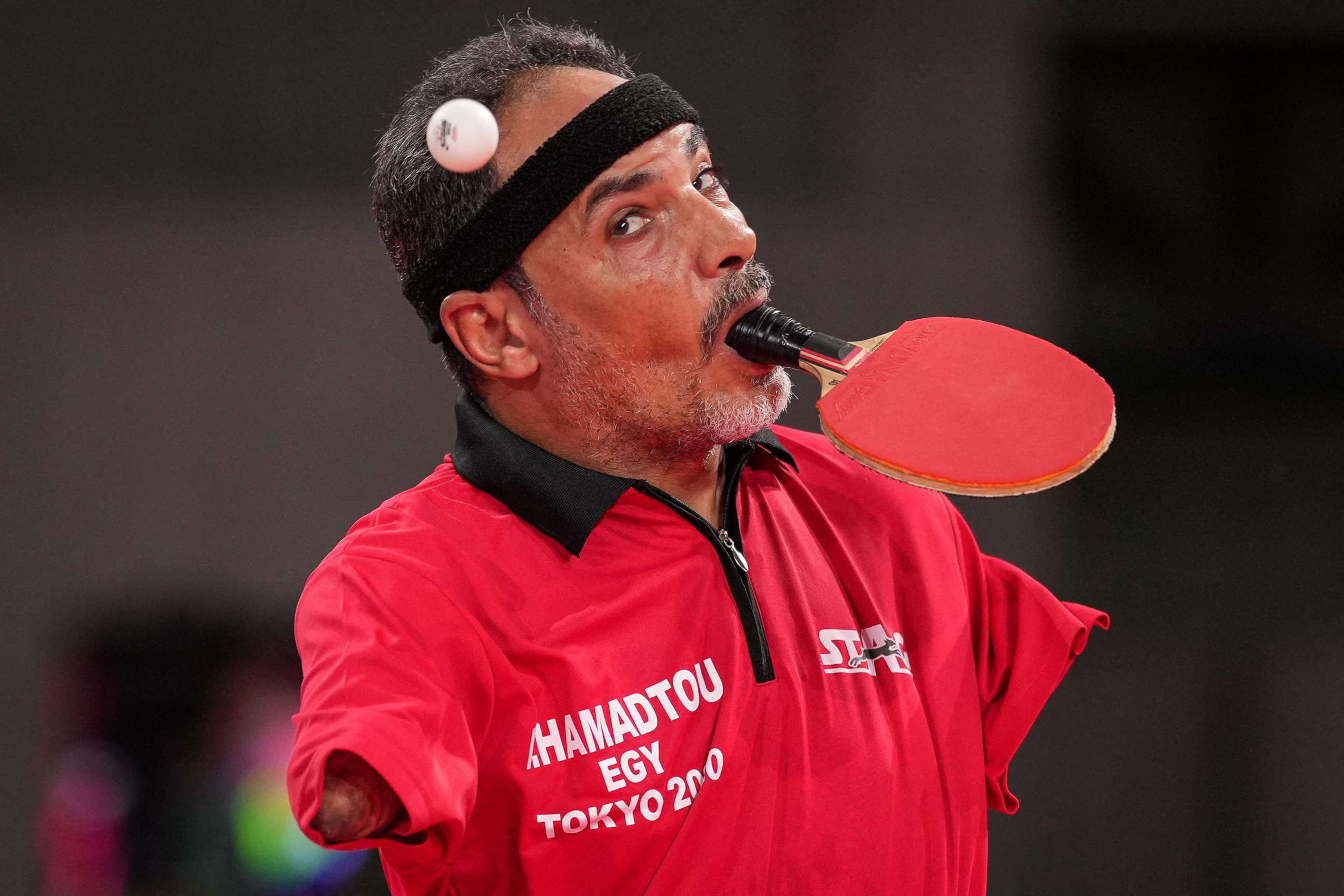 PHOTO: Egypt's Ibrahim Elhusseiny Hamadtou makes a first serve during the men's table tennis singles (Class 6) Group match against China's Chao Chen at th Paralympic Games at Tokyo Metropolitan Gymnasium in Tokyo on Aug. 27, 2021.