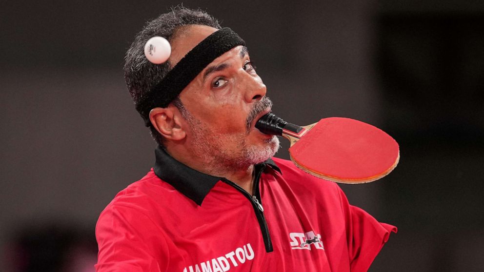 PHOTO: Egypt's Ibrahim Elhusseiny Hamadtou makes a first serve during the men's table tennis singles (Class 6) Group match against China's Chao Chen at th Paralympic Games at Tokyo Metropolitan Gymnasium in Tokyo on Aug. 27, 2021.