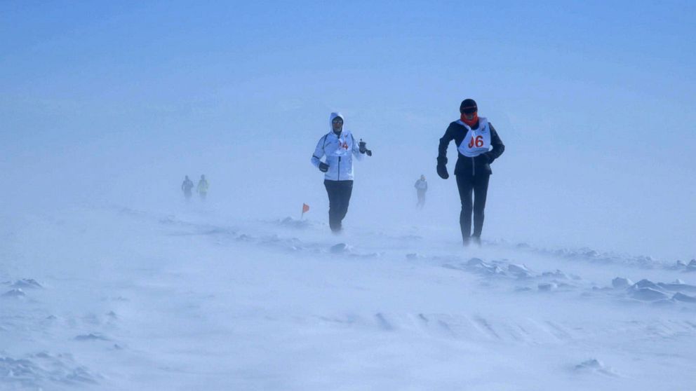 PHOTO: Runners run through blizzard conditions during the Baikal Ice Marathon in Siberia.