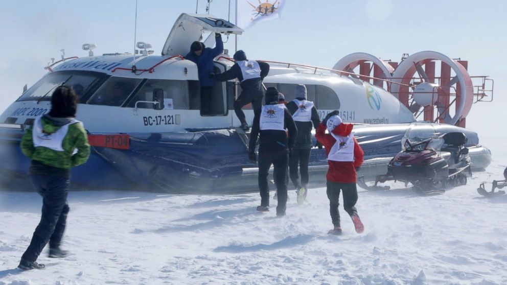 Runners are evacuated via hovercraft after the Baikal Ice Marathon was postponed due to inclement weather.